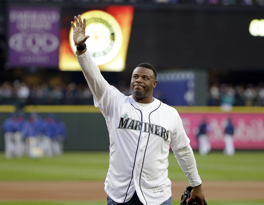 FILE  - Former Seattle Mariners outfielder Ken Griffey Jr. waves to fans after being introduced before a baseball game against the Texas Rangers in Seattle, in this Friday, April 14, 2017, file photo. Hall of Famer Ken Griffey Jr. is investing in the Seattle Mariners in a way he never has before. He'll be part of the ownership going forward. The Mariners announced Monday, Oct. 25, 2021, that their most famous former player has also become the first one to purchase a stake in the ball club.