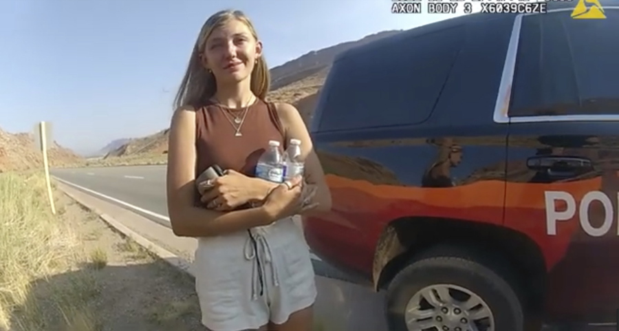 FILE - This police camera video provided by The Moab Police Department shows Gabrielle "Gabby" Petito talking to a police officer after police pulled over the van she was traveling in with her boyfriend, Brian Laundrie, near the entrance to Arches National Park on Aug. 12, 2021.  Teton County Coroner Brent Blue is scheduled to announce the findings of Petito's autopsy at a news conference early Tuesday, Oct. 12.