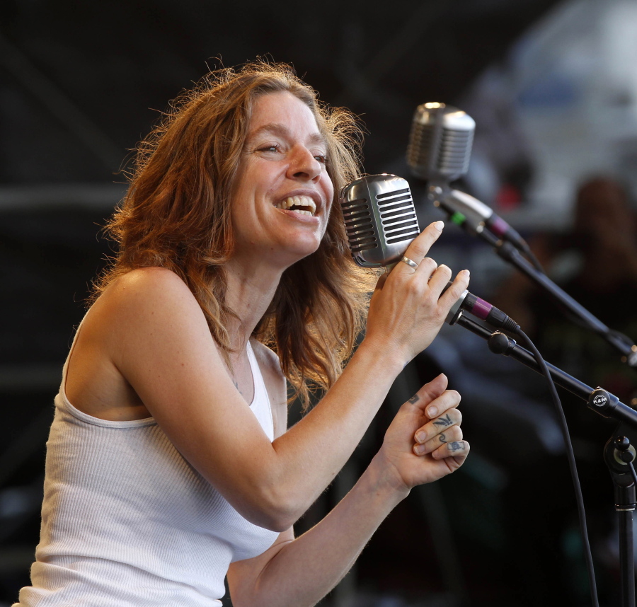 FILE - In this May 6, 2012 file photo, Ani DiFranco performs with the Preservation Hall Jazz Band at the New Orleans Jazz and Heritage Festival in New Orleans.  DiFranco is the honoree and will perform at the 41st annual John Lennon tribute concert in December in New York.  DiFranco shares a drive toward social activism with the late Beatle, a point noted in a statement from his widow Yoko Ono.