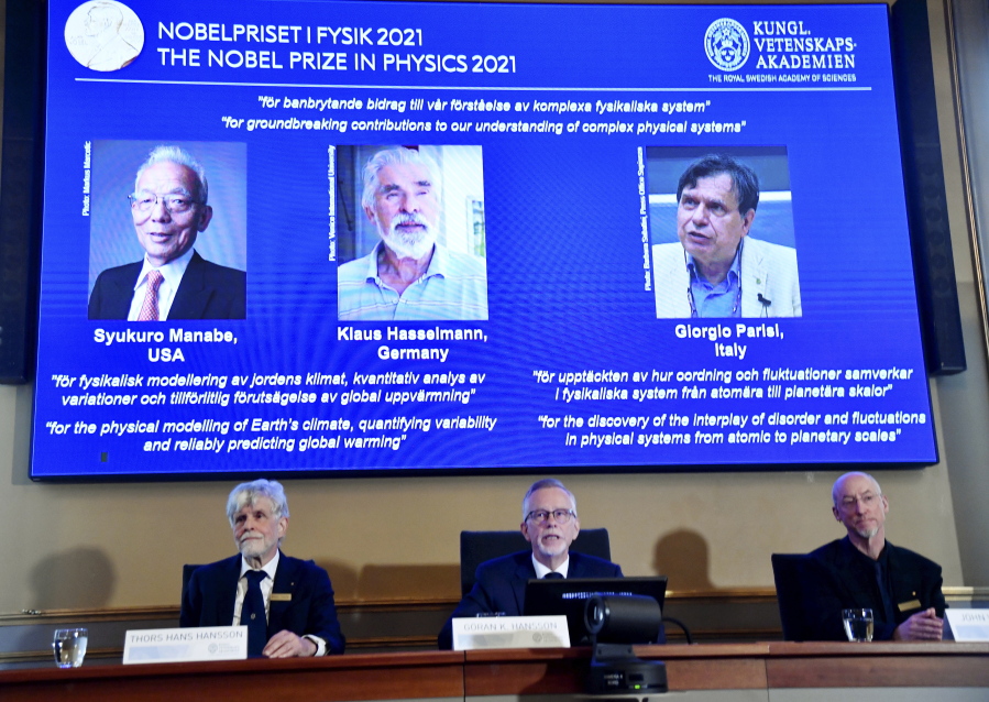 Secretary General of the Royal Swedish Academy of Sciences Goran Hansson, center, flanked at left by member of the Nobel Committee for Physics Thors Hans Hansson, left, and member of the Nobel Committee for Physics John Wettlaufer, right, announces the winners of the 2021 Nobel Prize in Physics at the Royal Swedish Academy of Sciences, in Stockholm, Sweden, Tuesday, Oct. 5, 2021. The Nobel Prize for physics has been awarded to scientists from Japan, Germany and Italy. Syukuro Manabe and Klaus Hasselmann were cited for their work in "the physical modeling of Earth's climate, quantifying variability and reliably predicting global warming".