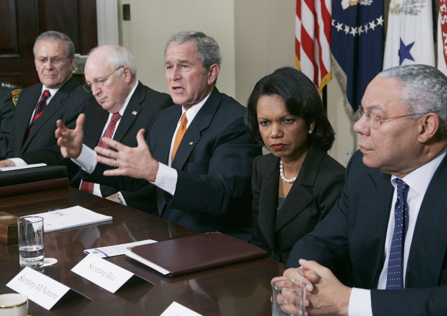 FILE - In this Jan. 5, 2006 file photo, President Bush, center, meets with Secretaries of State and Defense in the Roosevelt Room at the White House. From left to right are Secretary of Defense Donald H. Rumsfeld, Vice President Dick Cheney, Bush, Secretary of State Condoleezza Rice, and former Secretary of State Colin Powell.  Powell, former Joint Chiefs chairman and secretary of state, has died from COVID-19 complications. In an announcement on social media Monday, the family said Powell had been fully vaccinated. He was 84.