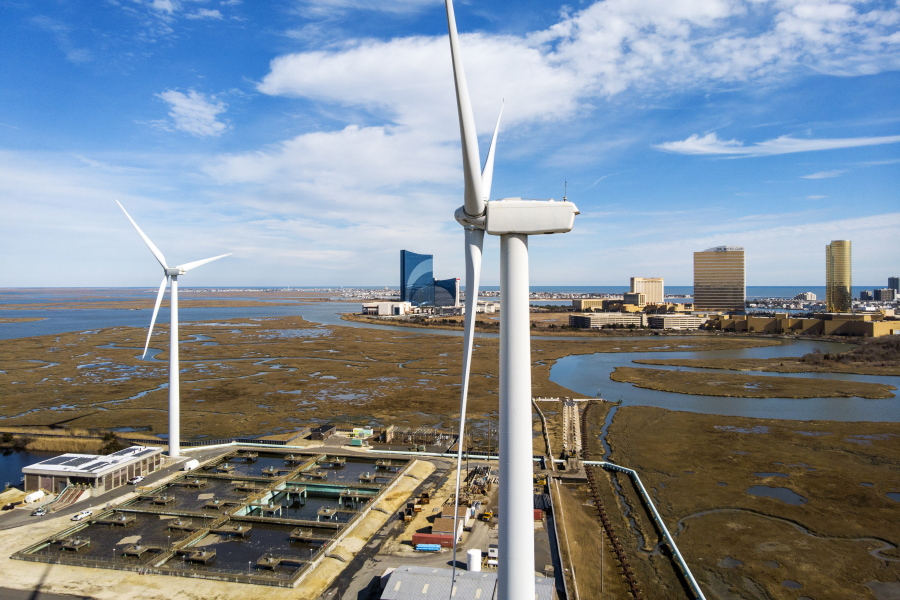 FILE - Wind turbines spin to generate electrical power in Atlantic City, N.J., on Wednesday, Feb. 17, 2021. A report released Tuesday, Oct. 12 by a group studying the economics of the offshore wind industry predicts that the industry's supply chain will be worth $109 billion over the next decade.