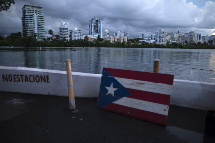 FILE - In this Sept. 30, 2021 file photo, a wooden Puerto Rican flag is displayed on the dock of the Condado lagoon in San Juan, Puerto Rico. The number of people in Puerto Rico who identified as "white" in the 2020 Census plummeted almost 80%, sparking a conversation about identity on an island breaking away from a past where race was not tracked and seldom debated in public.