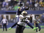 New Orleans Saints' Demario Davis (56) breaks up a pass intended for Seattle Seahawks' DK Metcalf in the final minute of Seattle's 13-10 loss on Monday in Seattle.