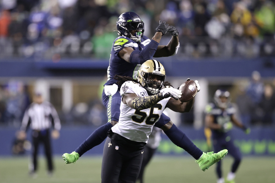 New Orleans Saints' Demario Davis (56) breaks up a pass intended for Seattle Seahawks' DK Metcalf in the final minute of Seattle's 13-10 loss on Monday in Seattle.