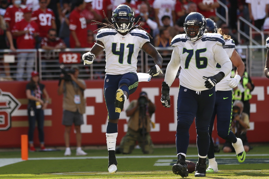Seattle Seahawks running back Alex Collins (41) celebrates after scoring a touchdown against San Francisco Sunday.