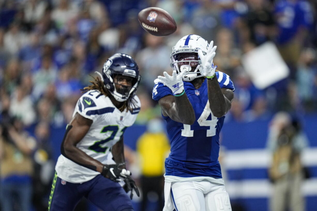 Indianapolis Colts wide receiver Zach Pascal (14) makes catch for a touchdown in front of Seattle Seahawks cornerback Tre Flowers (21) during the second half of an NFL football game in Indianapolis, Sunday, Sept. 12, 2021.