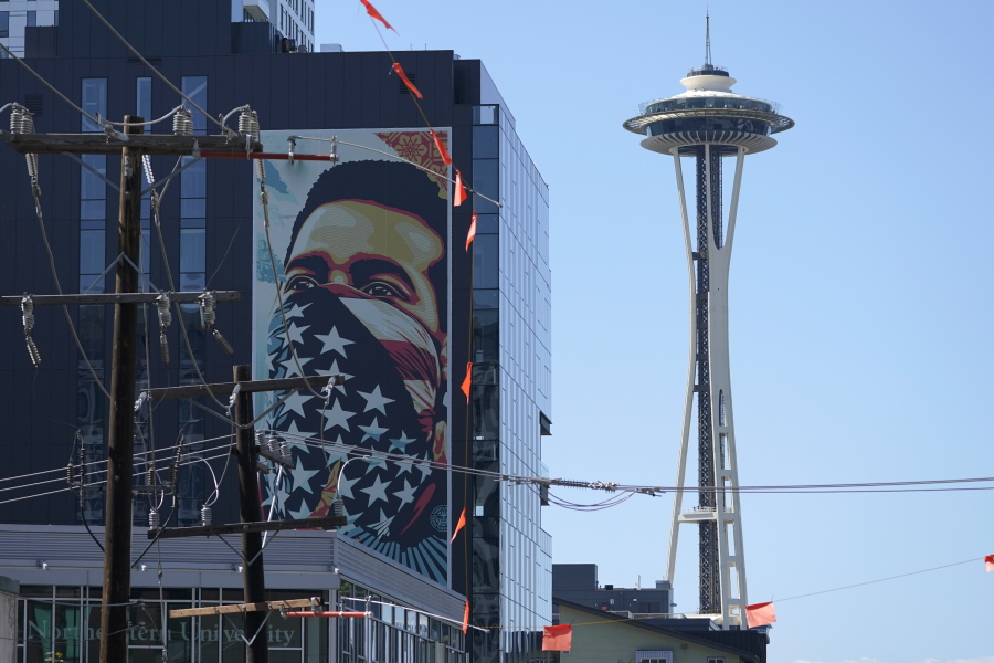A painting by Shepard Fairey, based on a photo taken by Ted Soqui during a Black Lives Matter protest, is projected onto a building near the Space Needle in Seattle in September. November's election for Seattle city attorney pits a Republican versus an extreme liberal candidate who wants to cease most prosecutions of misdemeanor cases, saying the existing system is racist.