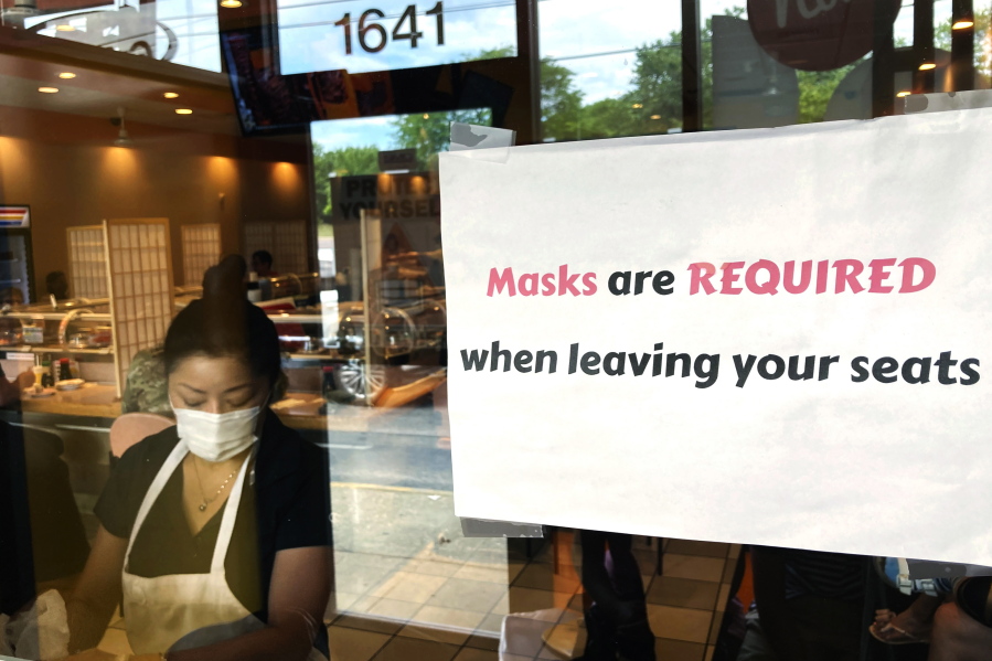 FILE - In this June 17, 2021, file photo, a sign requiring masks is displayed at a restaurant in Rolling Meadows, Ill. (AP Photo/Nam Y.