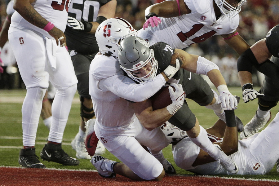 Washington State running back Max Borghi, center right, runs for a touchdown as Stanford linebacker Andres Fox defends during the second half of an NCAA college football game Saturday, Oct. 16, 2021, in Pullman, Wash. Washington State won 34-31.