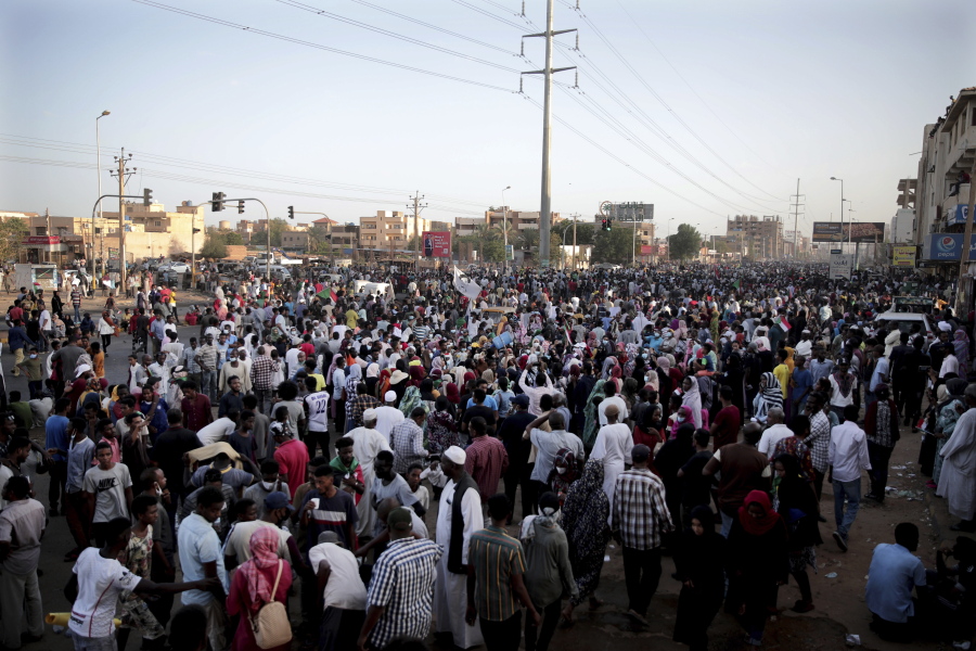 People gather during a protest in Khartoum, Sudan, Saturday, Oct. 30, 2021. Pro-democracy groups called for mass protest marches across the country Saturday to press demands for re-instating a deposed transitional government and releasing senior political figures from detention.