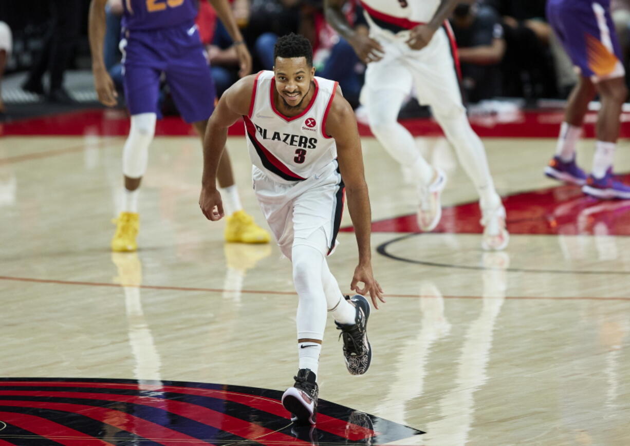 Portland Trail Blazers guard CJ McCollum gestures after making a 3-point basket against the Phoenix Suns during the second half of an NBA basketball game in Portland, Ore., Saturday, Oct. 23, 2021.