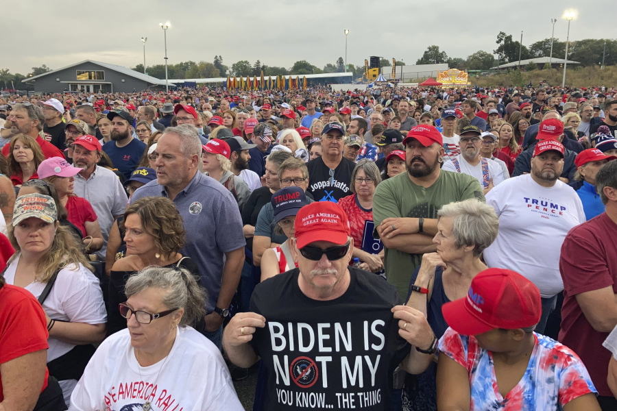 People gather ahead of an appearance by former President Donald Trump at a rally at the Iowa State Fairgrounds in Des Moines, Iowa., Saturday, Oct. 9, 2021.