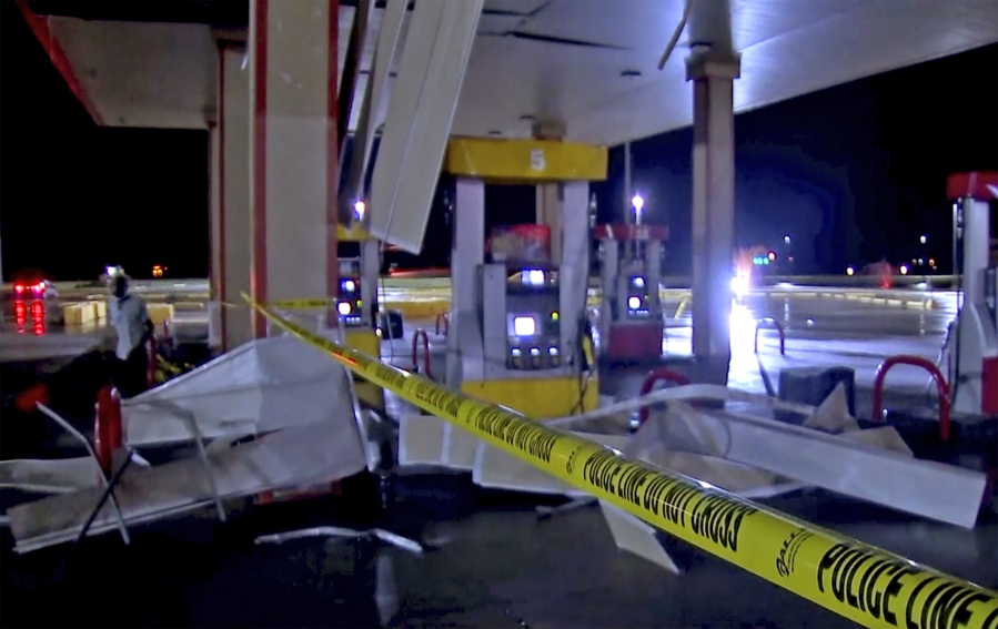In this image made from video, debris from tornadoes pile around the pumps of a filling station late Sunday, Oct. 10, 2021, in Shawnee, Oklahoma. Several reported tornadoes ripped through Oklahoma late Sunday into early Monday morning, causing damage but no immediate word of deaths or injuries.