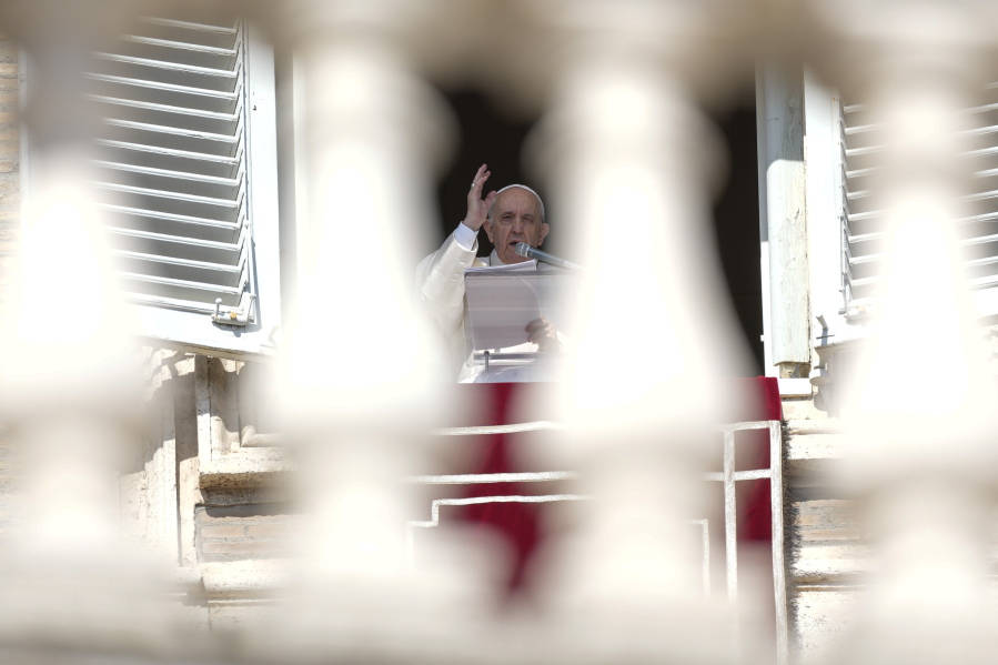 Pope Francis delivers his blessing as he recites the Angelus noon prayer from the window of his studio overlooking St.Peter's Square, at the Vatican, Sunday, Oct. 24, 2021.