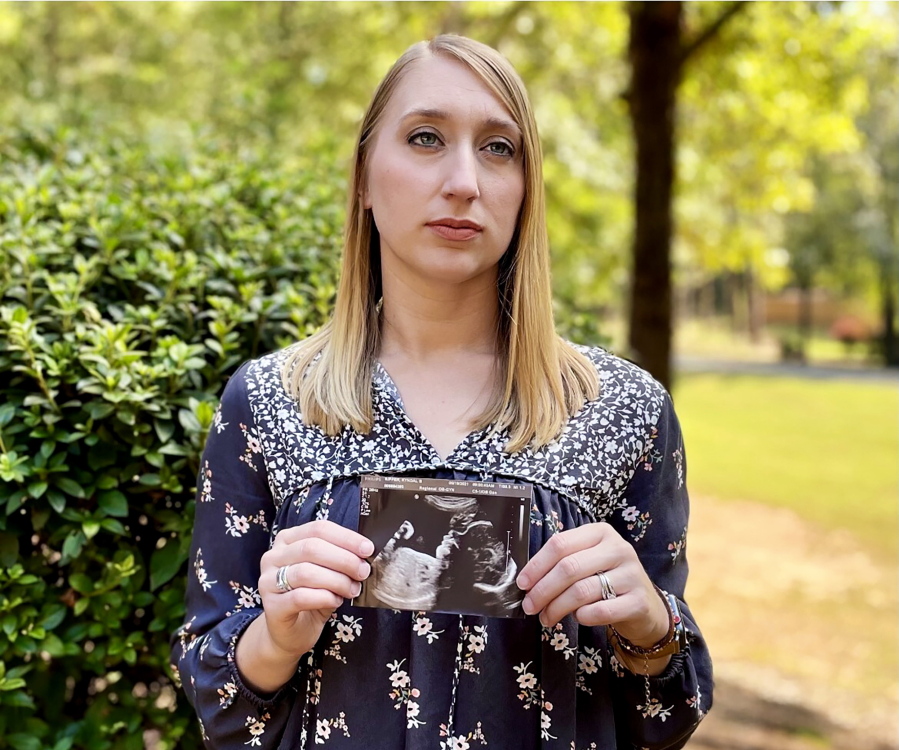 Kyndal Nipper, of Midland, Ga., who suffered a stillbirth after becoming ill with COVID-19 in her third trimester, holds an ultrasound image of the son she lost.