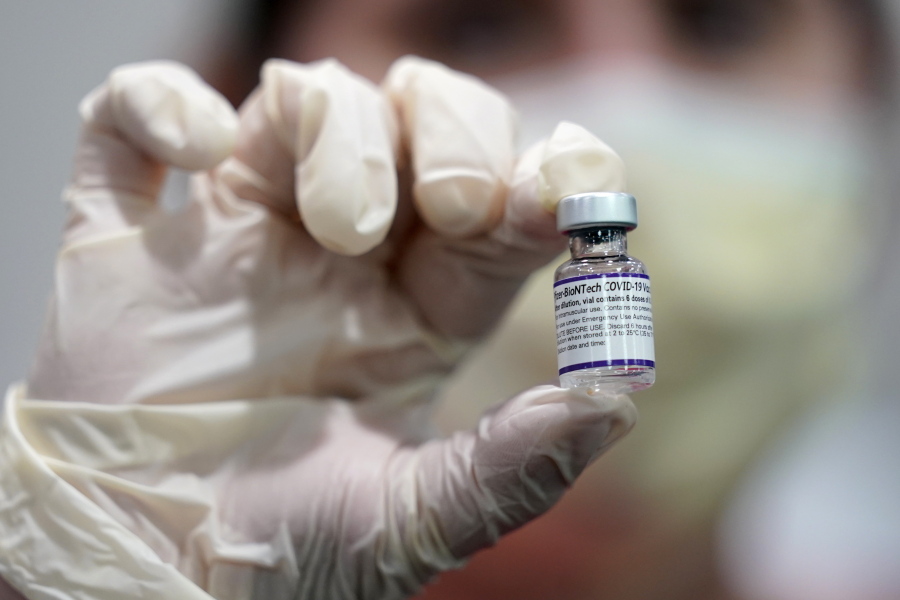 FILE - A healthcare worker holds a vial of the Pfizer COVID-19 vaccine at Jackson Memorial Hospital in Miami, in this Tuesday, Oct. 5, 2021, file photo. Pfizer asked the U.S. government Thursday, Oct. 7, 2021, to allow use of its COVID-19 vaccine in children ages 5 to 11 -- and if regulators agree, shots could begin within a matter of weeks.