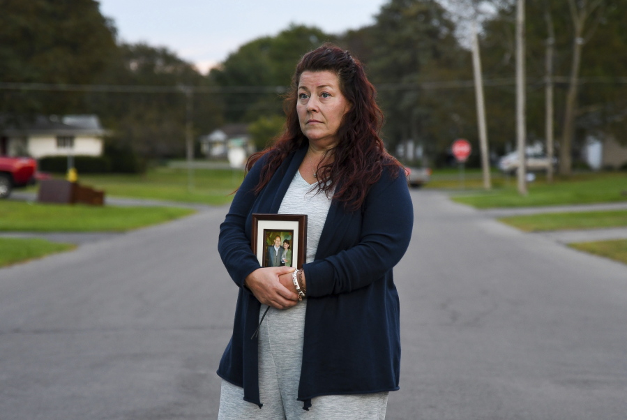 Natalie Walters, 53, holds a photo of her parents, Jack and Joey Walters, near her home in Syracuse, N.Y., Tuesday, Sept. 21, 2021. Walters' father, who was staying at the Loretto Health and Rehabilitation nursing home in Syracuse, died of COVID-19 in December 2020. The facility's staffing has declined during the pandemic and Walters wonders if poor staffing played a role in her father's infection or death. Nationwide, one-third of U.S. nursing homes have fewer nurses and aides than before COVID-19 began ravaging their facilities, an Associated Press analysis of federal data finds.