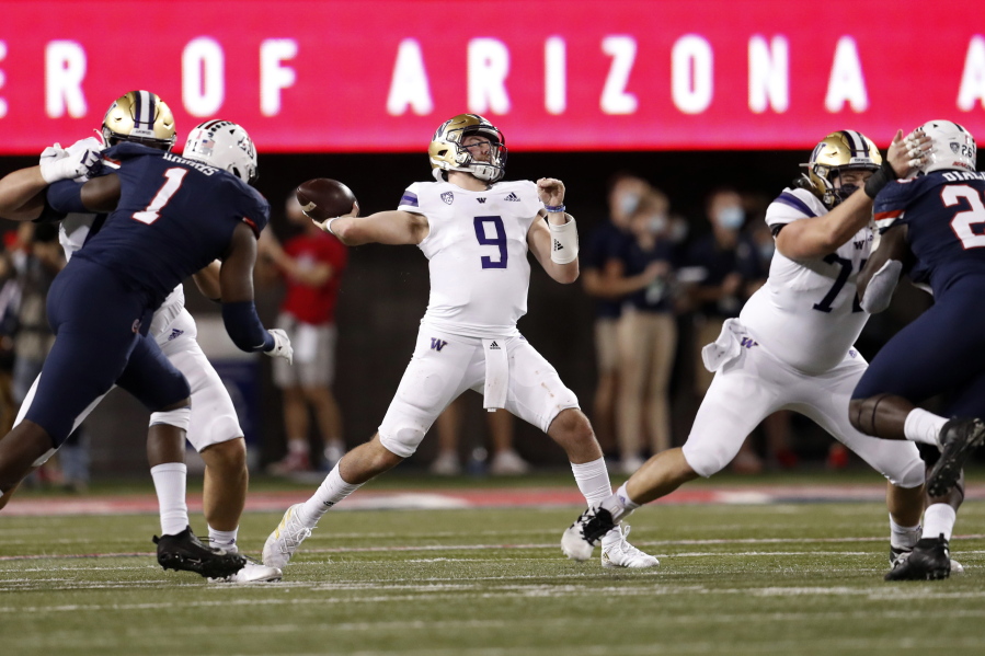 Washington quarterback Dylan Morris (9) throws a pass during the first half of the team's NCAA college football game against Arizona on Friday, Oct. 22, 2021, in Tucson, Ariz.