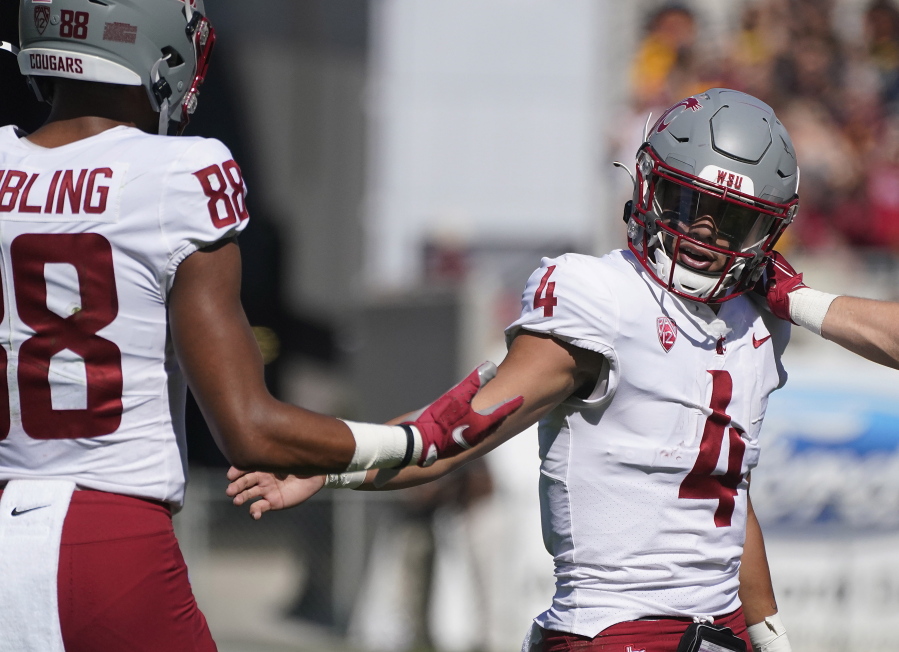 Washington State quarterback Jayden deLaura (4) gets congratulations from De'Zhaun Stribling (88) after scoring a touchdown against Arizona State during the first half of an NCAA college football game, Saturday, Oct 30, 2021, in Tempe, Ariz.