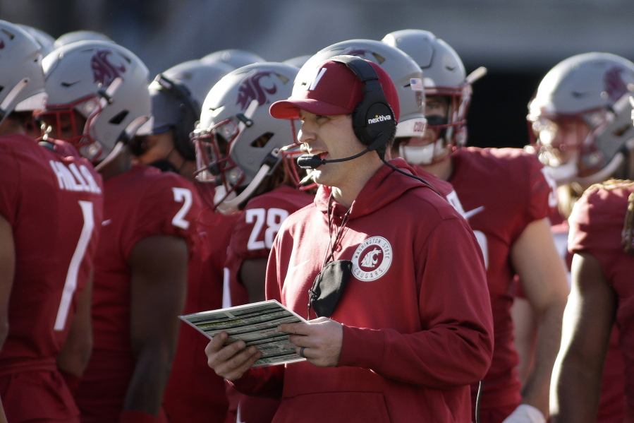 Washington State defensive coordinator and linebackers coach Jake Dickert, center, was named interim head coach on Monday.
