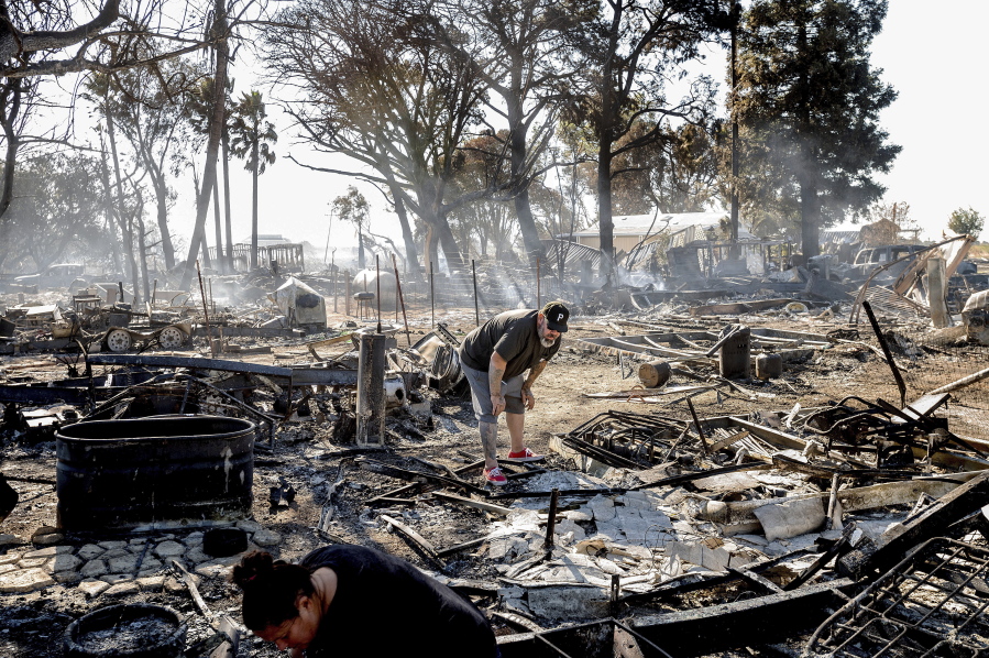 James Grooms looks through the remains of his home at the Rancho Marina Mobile Home & RV Park following the Brannan Fire in Sacramento County, Calif., on Tuesday, Oct. 12, 2021. Fueled by dry, strong winds, the blaze leveled dozens of residences on Brannan Island Monday afternoon.