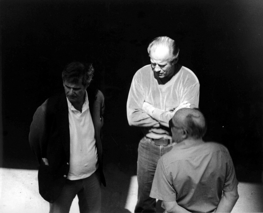 This 1980 black and white surveillance photo released by the U.S. Attorney's Office and presented as evidence during the first day of a trial for James "Whitey" Bulger in U.S. District Court in Boston, Wednesday, June 12, 2013, shows Bulger, center, with Ted Berenson, left, and Phil Wagenheim at a Lancaster Street garage in Boston's North End. Three years after he was bludgeoned to death in a West Virginia prison, no one has been charged in the beating death of murderous Boston crime boss James "Whitey" Bulger. Bulger was 89 when he was fatally beaten in October 2018. (AP Photo/U.S.