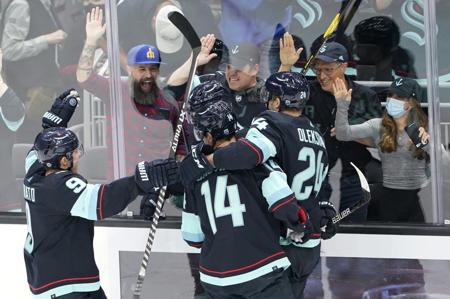 Seattle Kraken players celebrate after Haydn Fleury scored against the Minnesota Wild during the second period of an NHL hockey game, Thursday, Oct. 28, 2021, in Seattle. (AP Photo/Ted S.
