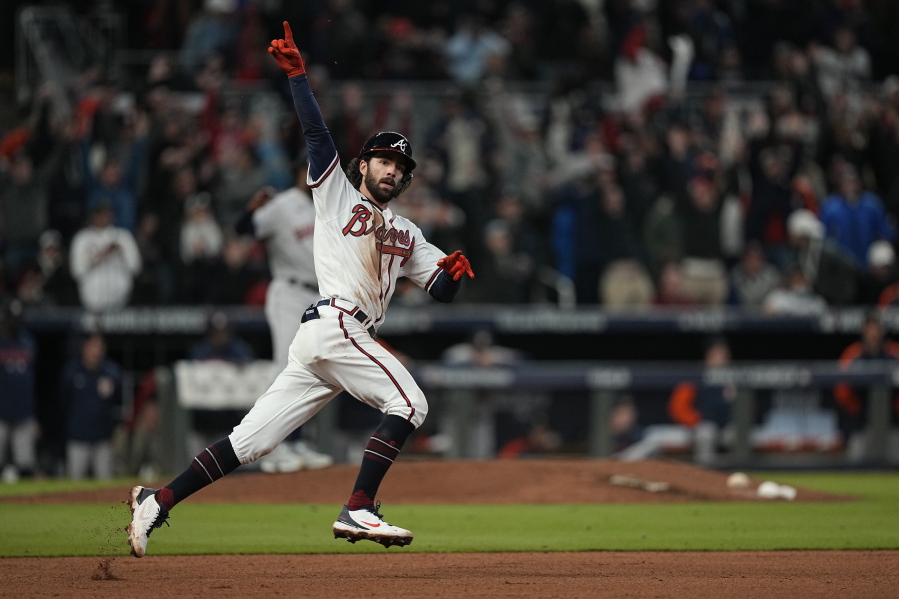Atlanta Braves' Dansby Swanson celebrates his home run during the seventh inning in Game 4 of baseball's World Series between the Houston Astros and the Atlanta Braves Saturday, Oct. 30, 2021, in Atlanta. (AP Photo/David J.