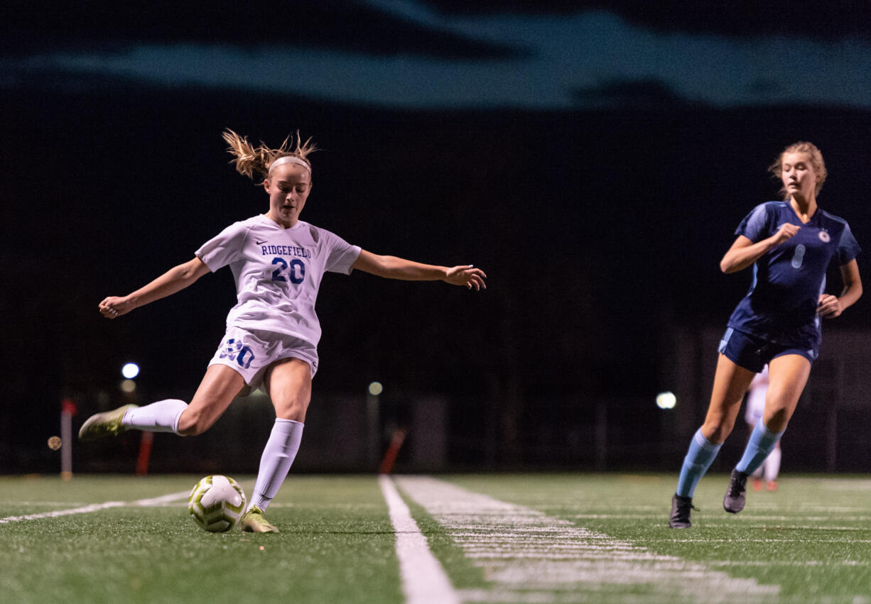 Ridgefield's Baylee Bushnell delivers a cross in the 2A District Girls Soccer Championship on Thursday, Nov. 4, 2021, at District Stadium in Battle Ground.