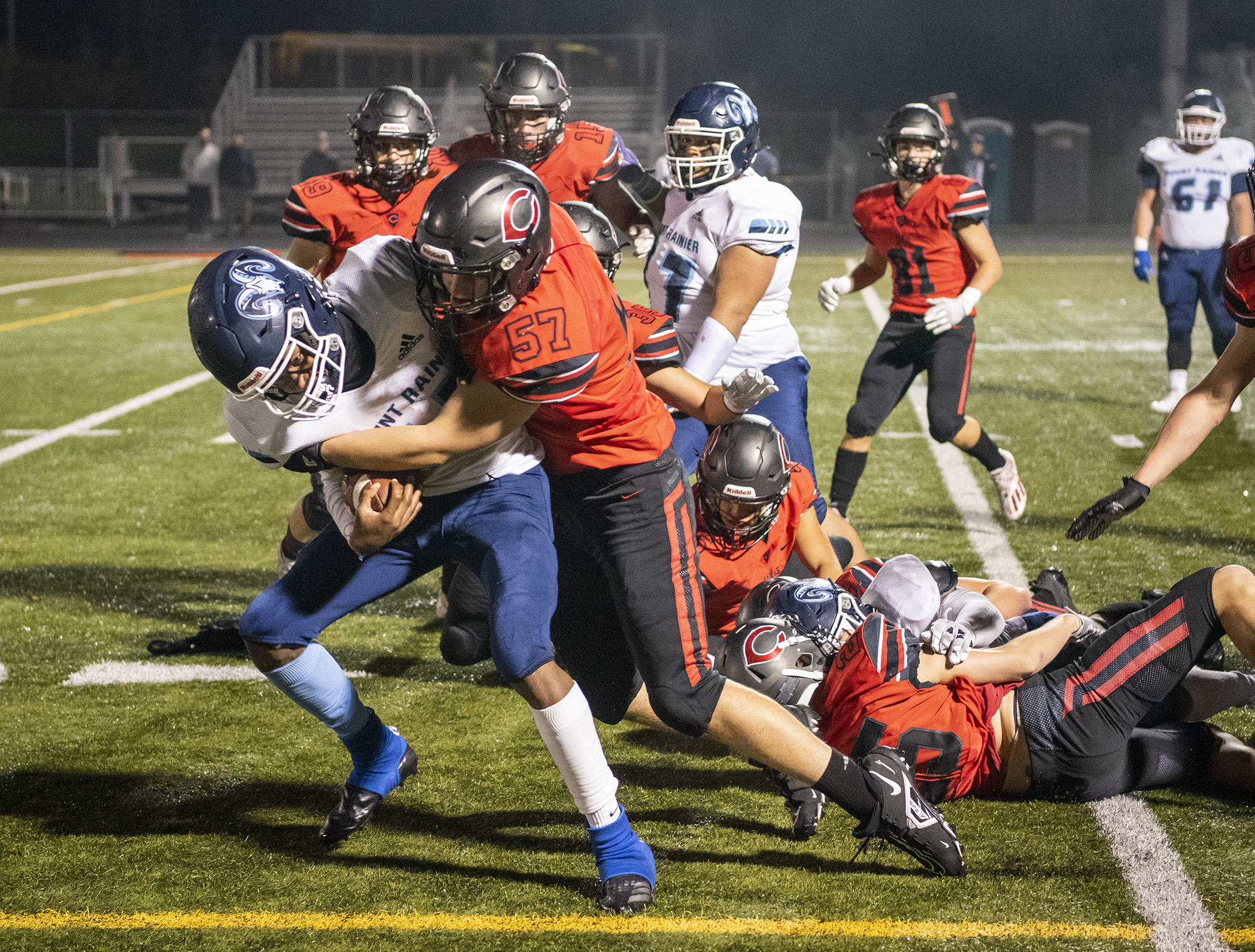 Camas High School defenders make a stop on a 2-point attempt Friday, Nov. 5, 2021, during the Papermakers’ 57-20 win against Mount Rainier in a 4A GSHL playoff game at Doc Harris Stadium.