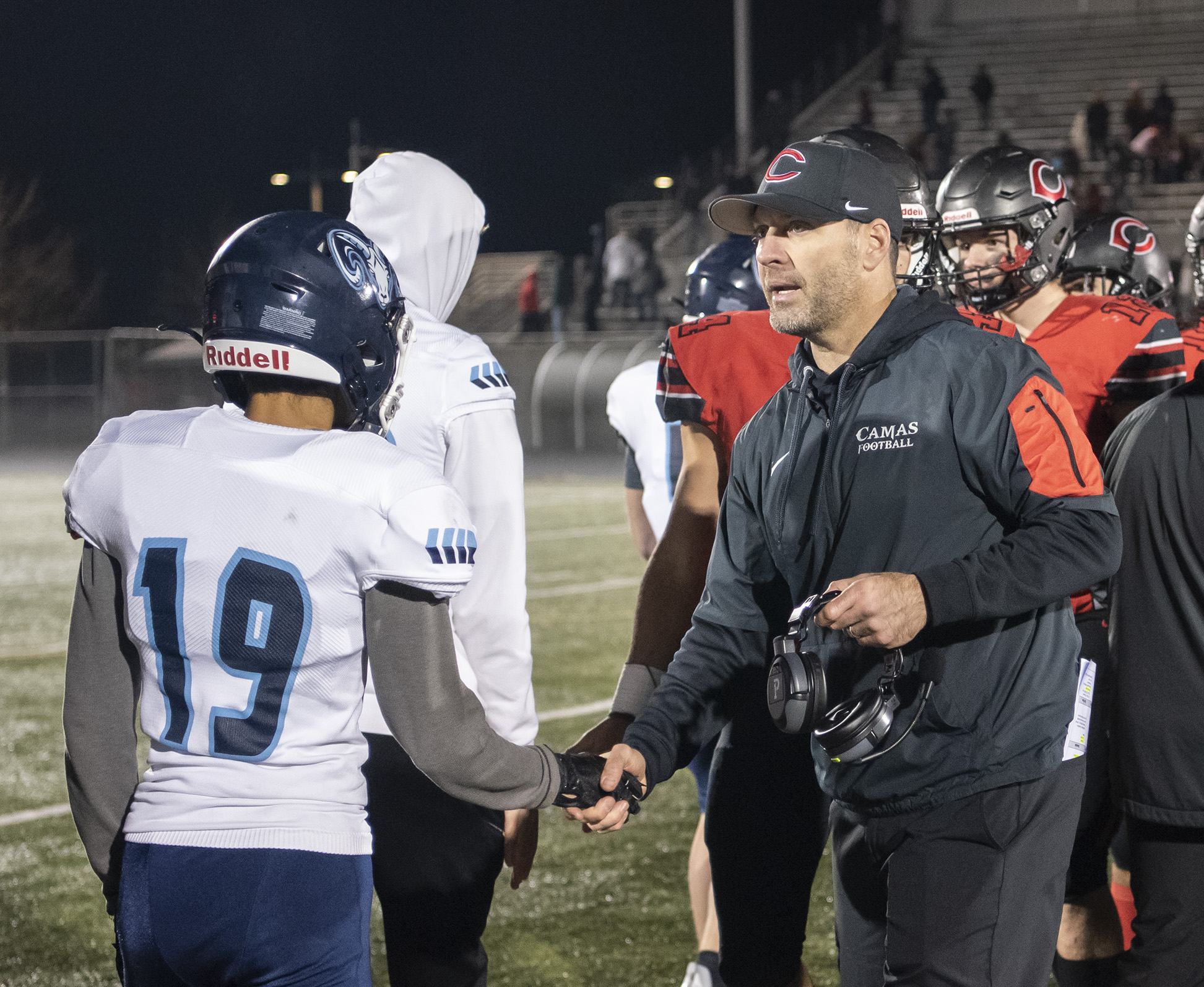 Camas head football coach Jack Hathaway, right, shakes hands Friday, Nov. 5, 2021, after the Papermakers’ 57-20 win against Mount Rainier in a 4A GSHL playoff game at Doc Harris Stadium.
