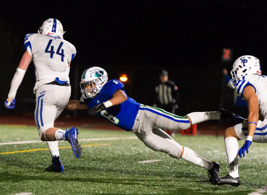 Mountain View's CJ Hamblin leaps in an attempt to make a touchdown-saving tackle of Seattle Prep's Austin Harnetiaux in a 3A State preliminary game on Saturday, Nov. 6, 2021, at McKenzie Stadium. Seattle Prep defeated Mountain View 38-27 to end the Thunder season.