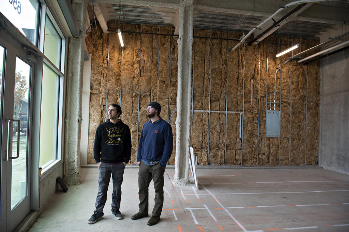 Ruse Brewing co-founders Shaun Kalis, left, and Devin Benware stand in the future bar area of their new pizza venture, Crust Collective, at The Waterfront Vancouver. It will feature their take on Detroit-style pizza.