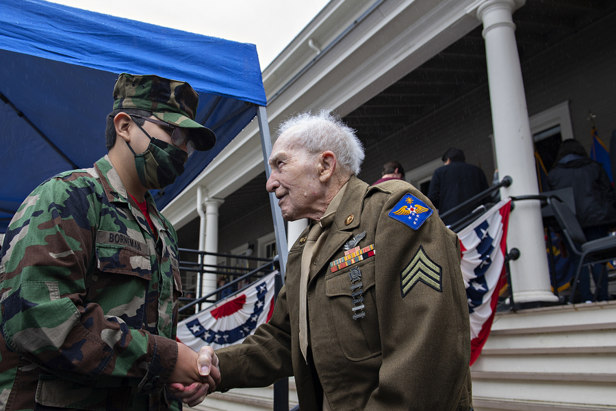 Kyle Borneman, left, 14, of the Lewis and Clark Young Marines greets World War II veteran Wilbert Kalmbach of Camas, 94, following the Veterans Day Ceremony at the Fort Vancouver Artillery Barracks on Thursday afternoon, Nov. 11, 2021. Kalmbach served his country in the Phillipines during WWII.