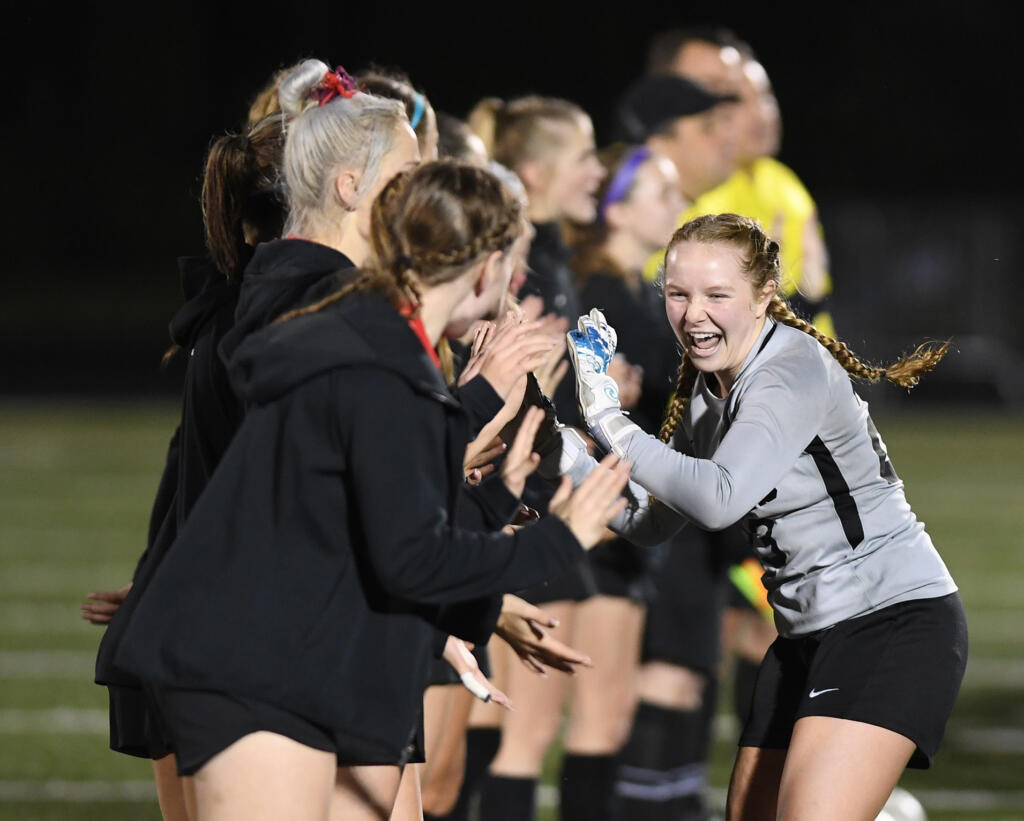 Camas junior Keely Wieczorek high fives the team during introductions Wednesday, Nov. 10, 2021, before the Papermakers' 2-0 win against Kennedy Catholic in the first round of the 4A state tournament at Doc Harris Stadium in Camas.
