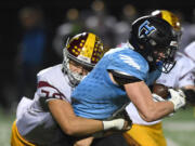 Hockinson junior Tyler Litle, right, runs downfield while being tackled by Enumclaw senior Mataala Tagaloa Friday, Nov. 12, 2021, during the Hawks’ 38-28 loss to Enumclaw at Battle Ground High School.