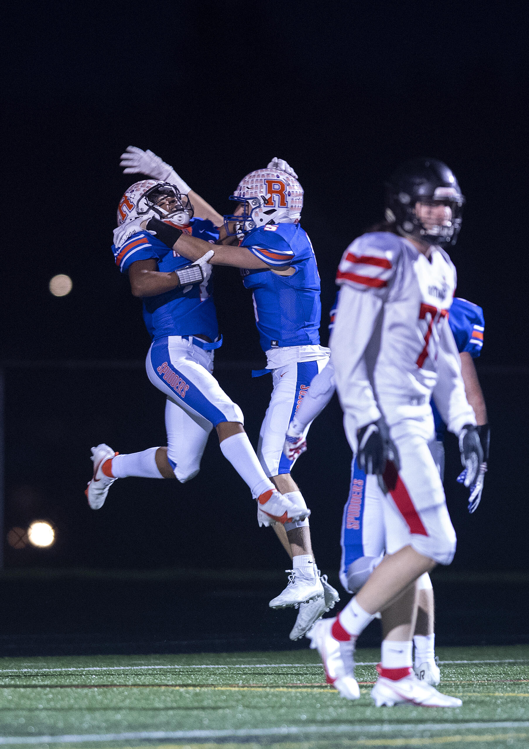 Ridgefield's Isaiah Cowley (1) celebrates his touchdown in the first quarter with teammate Ty Snider at Ridgefield High School on Saturday night, Nov. 13, 2021.