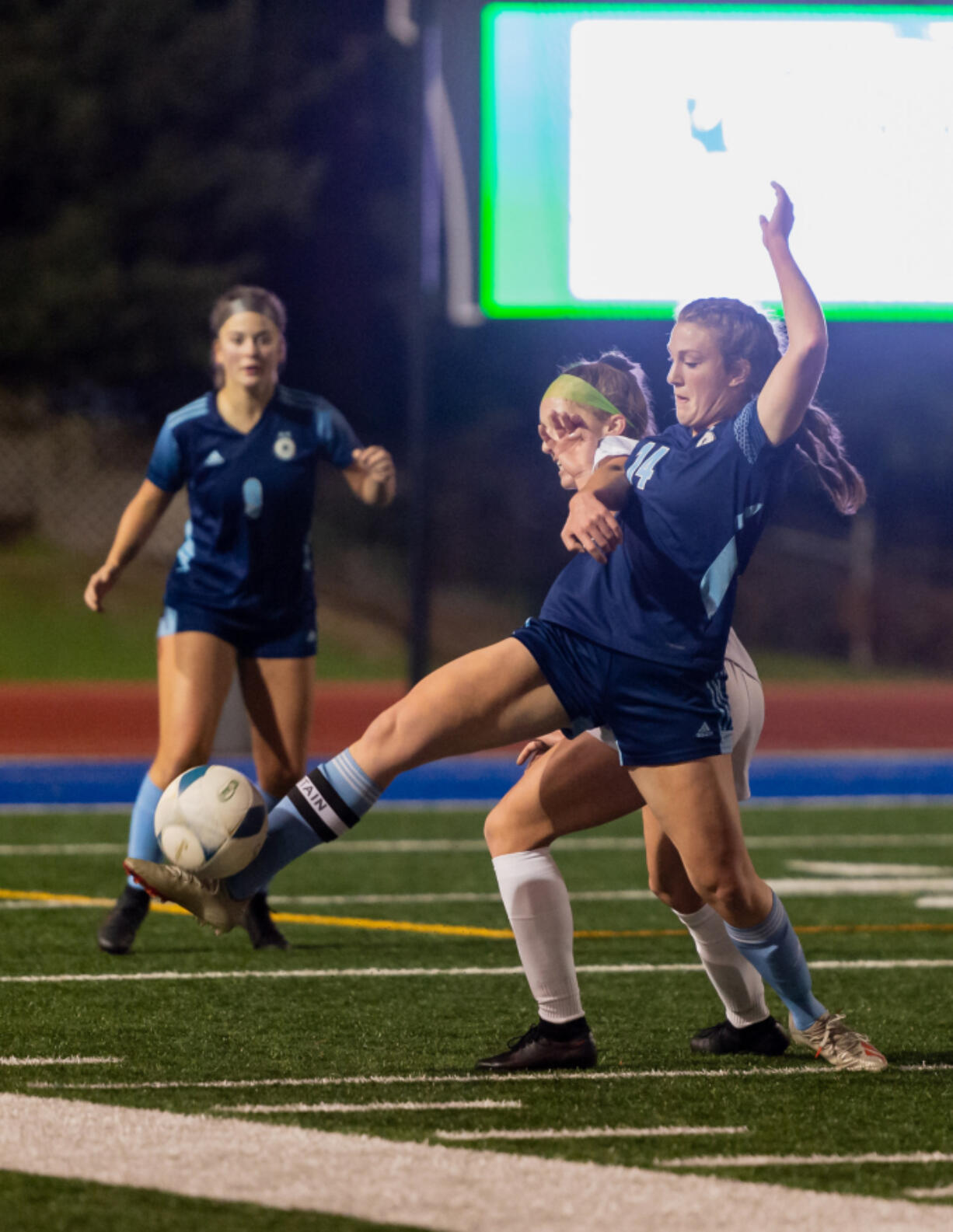 Ridgefield's Claire Jones and Hockinson's Molly Romanchock compete for the ball during the 2A state soccer semifinal on Friday at Shoreline Stadium. Hockinson won 1-0 and will play in the final on Saturday.