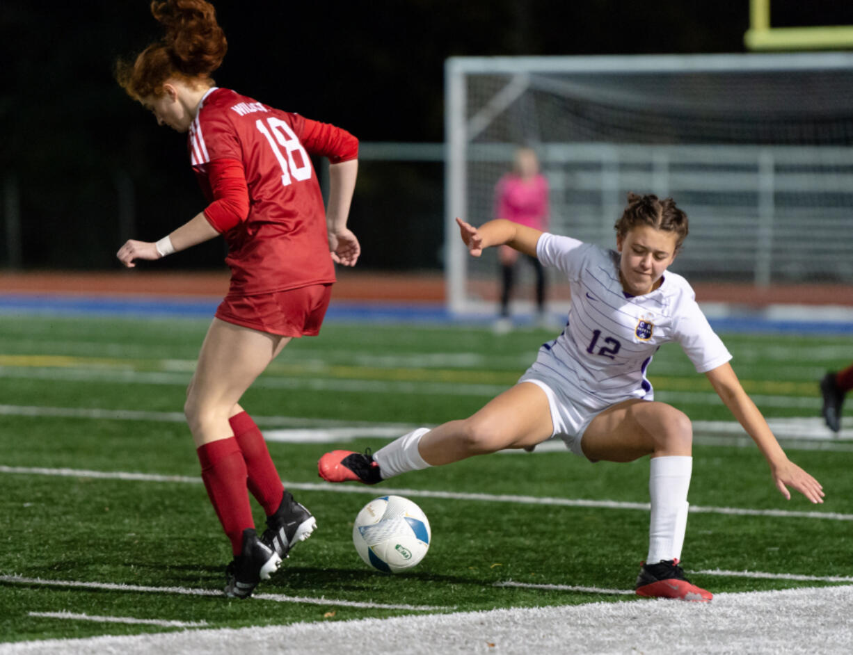 Columbia River's Anna Iniguez is tripped up by Archbishop Murphy's Brie Cote during the 2A state soccer semifinal on Friday at Shoreline Stadium.