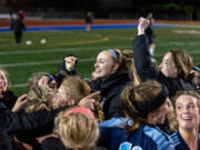 Hockinson players celebrate a 1-0 victory in a 2A State soccer semifinal on Friday, Nov. 19, 2021, at Shoreline Stadium.