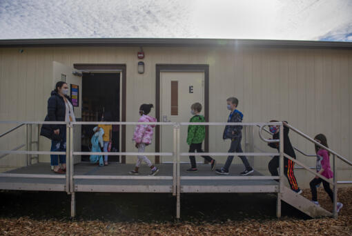 Substitute teacher Alison Davies, left, holds the door while leading second-graders back to their classroom at Union Ridge Elementary School  on Nov. 17.