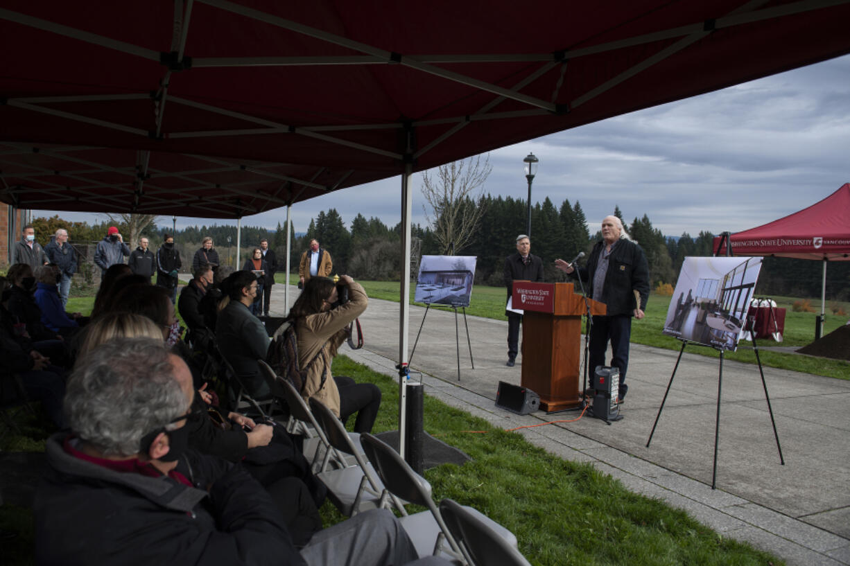 Roben White, at podium, a member of the Washington State University Vancouver's Native American Community Advisory Board, gives a blessing during the ground breaking ceremony Thursday morning. White is a descendant of the Cheyenne and Lakota tribes.