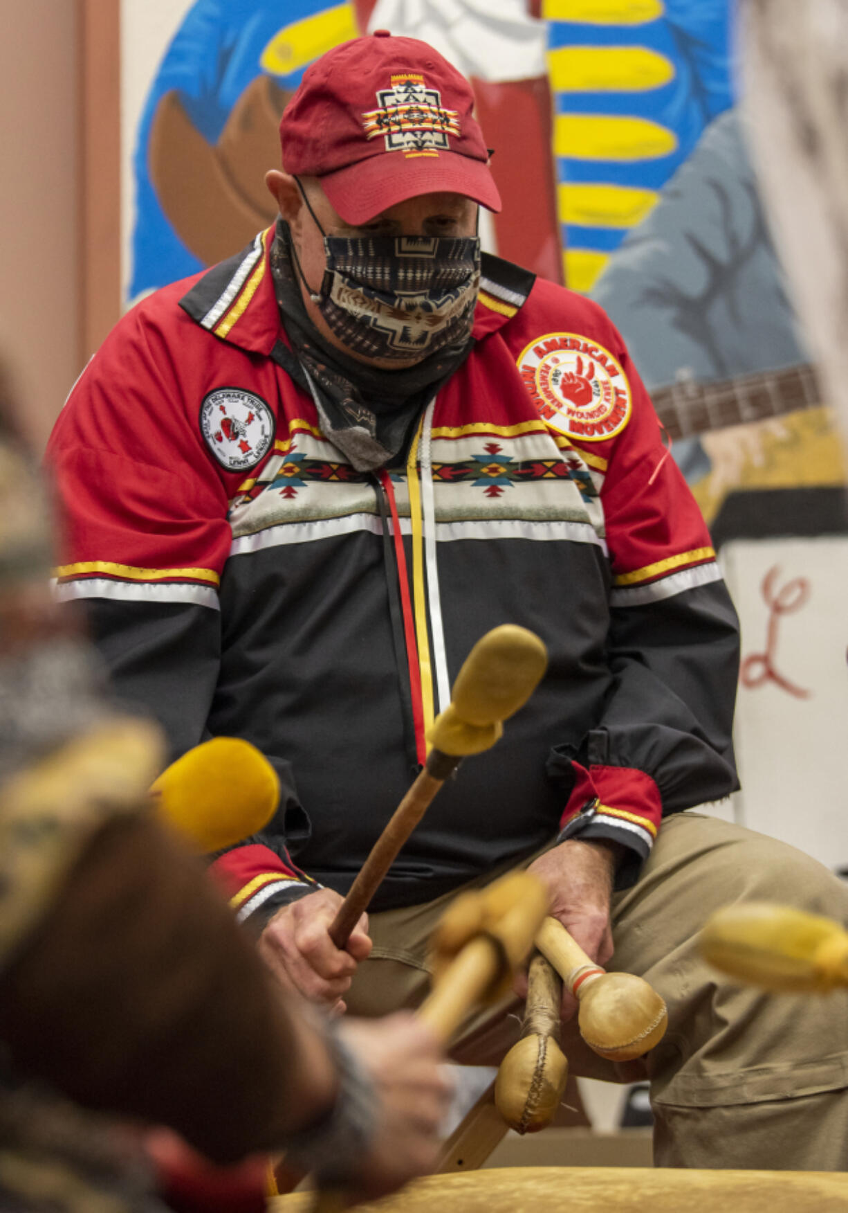 Pastor Joe Scheeler performs with Traveling Day Society on Tuesday at Lincoln Elementary School. The group played two songs to begin the event: the Eagle Spirit song and Bear Spirit song, both of which come from Anishinaabe culture.