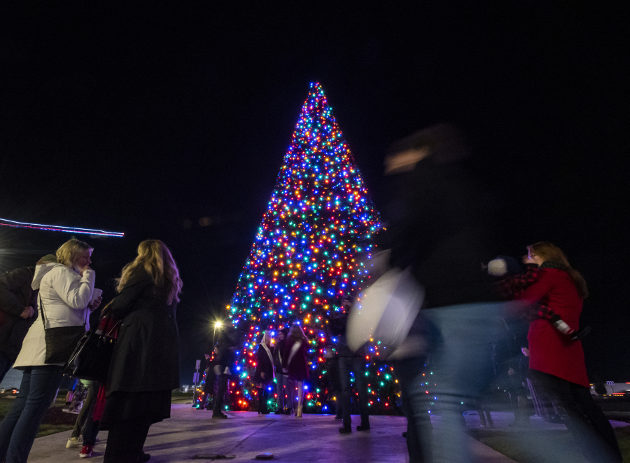 People mill around a 54-foot Christmas tree on Wednesday evening at a tree lighting event at ilani on the Cowlitz Indian Reservation.