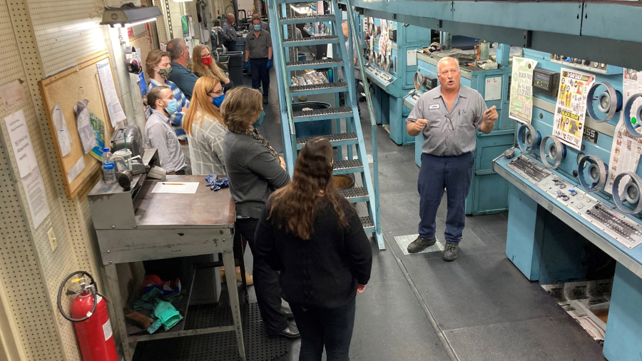 Press operator Steve Fessler talks with newsroom employees about the intricacies of working The Columbian's Goss Metro offset press on Tuesday before the paper's Thanksgiving edition went to press.
