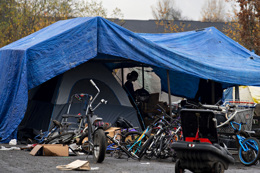 Residents clear out their belongings from a homeless encampment in the North Image neighborhood Monday afternoon to comply with Vancouver's camping ordinance. According to the rule, there can't be unrestricted camping within 1,200 feet of Safe Stay Communities.