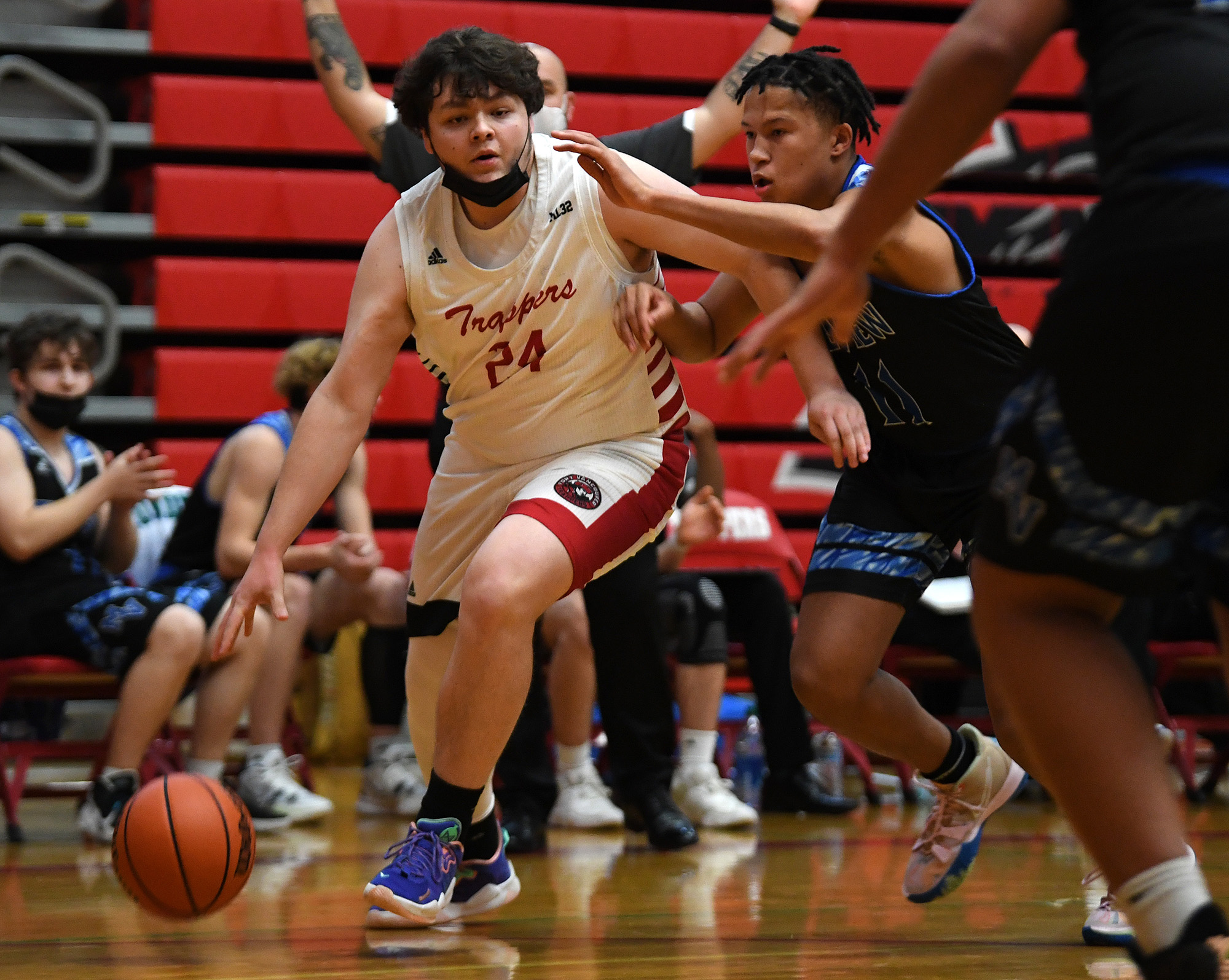 Fort Vancouver senior Dean Cadena, left, dribbles the ball under pressure from Mountain View junior Michael Tauscher on Tuesday, Nov. 30, 2021, during the Trappers’ 73-46 loss to the Thunder at Fort Vancouver High School.