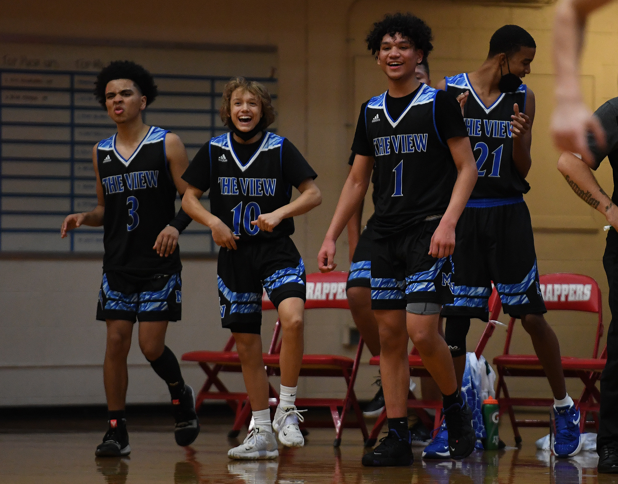 Mountain View players celebrate a halftime buzzer beater on Tuesday, Nov. 30, 2021, during the ThunderÕs 73-46 win against the Trappers at Fort Vancouver High School.