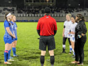 Players from La Center, left, and Elma meet with the referee before the start of overtime in a Class 1A District 4 semifinal match on Thursday at La Center High.
